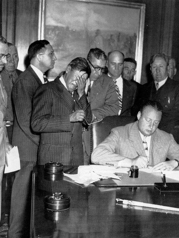 Tribal president George Gillette weeps at the signing of agreement to cede land for the Garrison Dam.