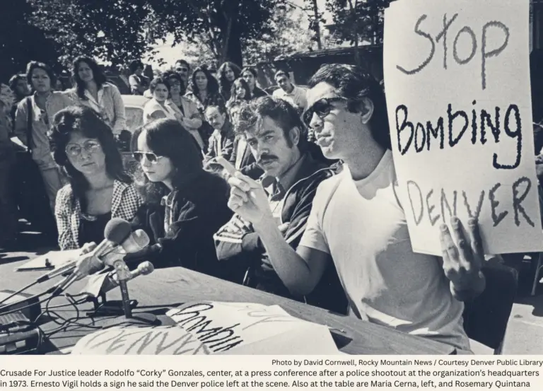 Corky Gonazles looks at the camera sitting in midst of three Crusade for Justice members at a news conference.
